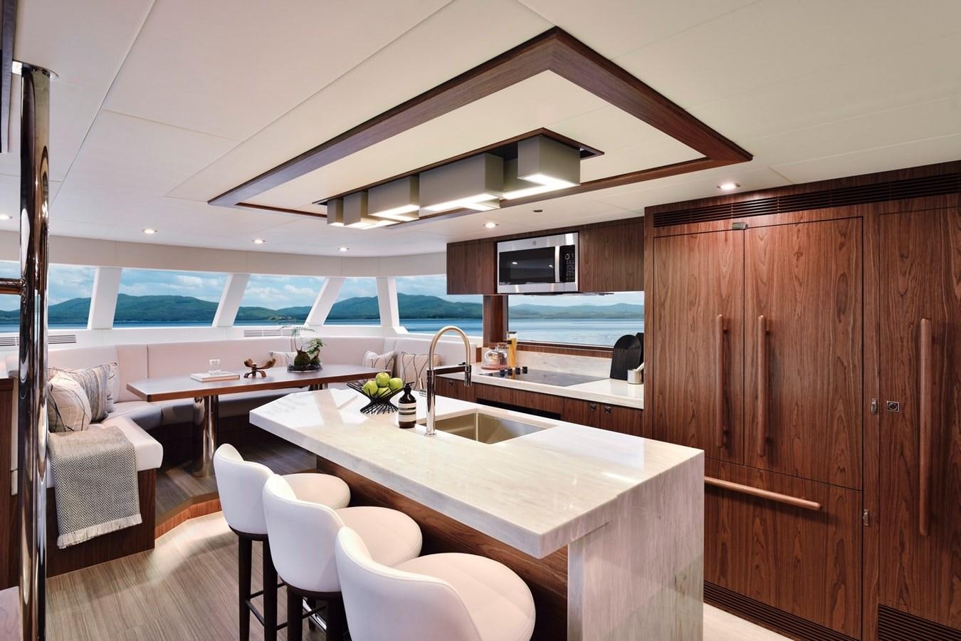 a kitchen with a table and chairs aboard HORIZON V77 CMY / AVAILABLE NOW Yacht for Sale