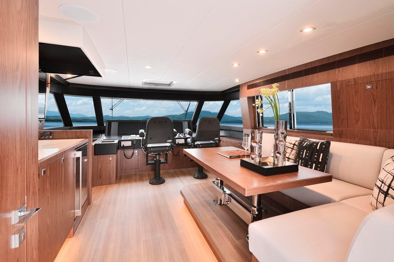 a room with a table and chairs aboard HORIZON V77 CMY / AVAILABLE NOW Yacht for Sale