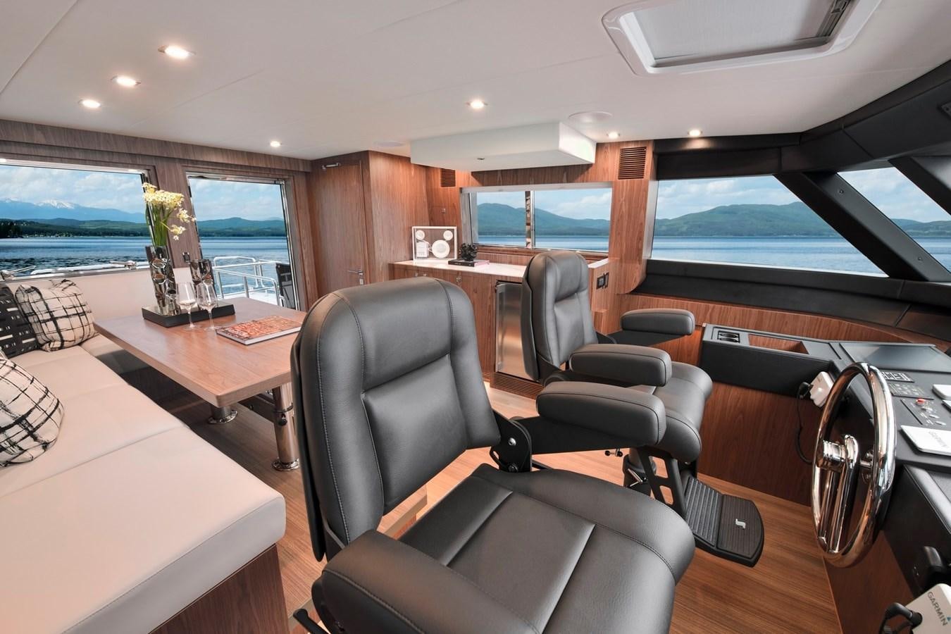 a room with a table chairs and a large window aboard HORIZON V77 CMY / AVAILABLE NOW Yacht for Sale