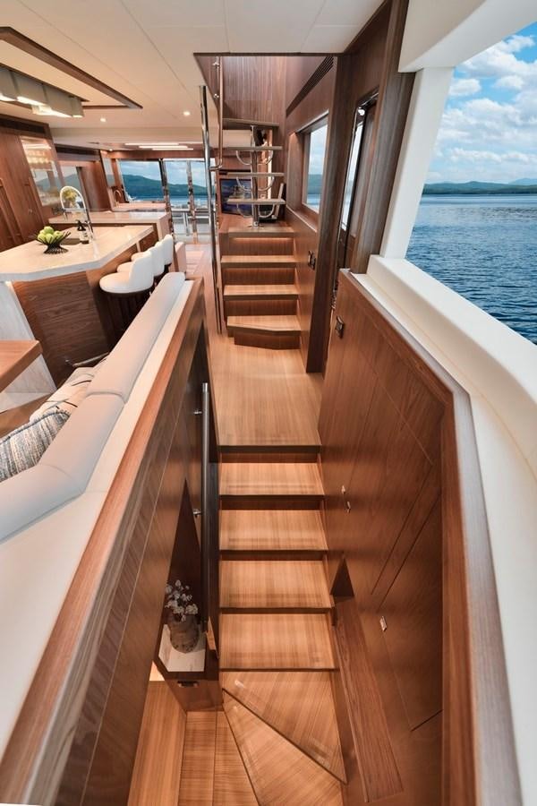 a wooden staircase leading to a balcony aboard HORIZON V77 CMY / AVAILABLE NOW Yacht for Sale