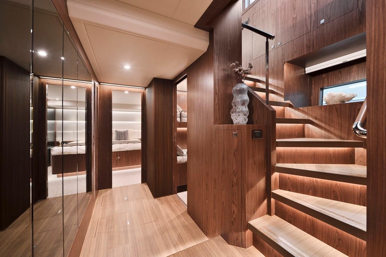 a wood staircase in a house aboard HORIZON V77 CMY / AVAILABLE NOW Yacht for Sale