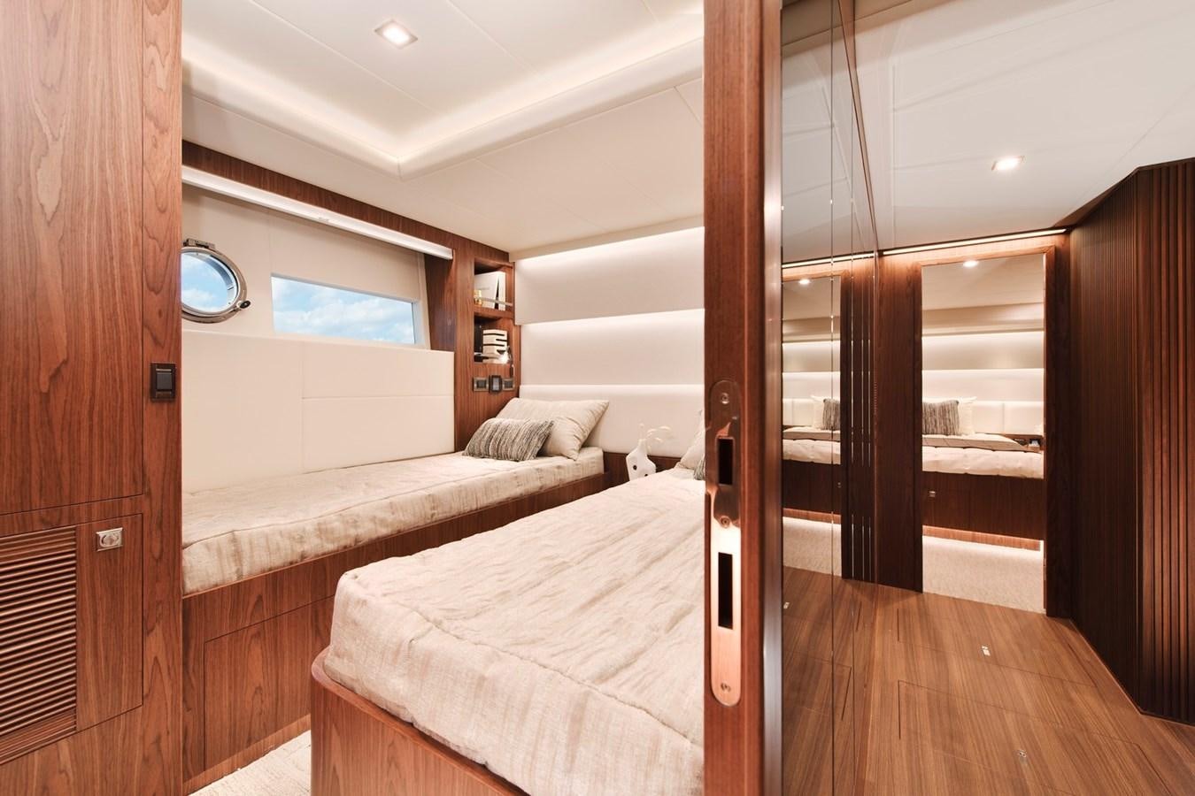 a room with a bed and a wood door aboard HORIZON V77 CMY / AVAILABLE NOW Yacht for Sale