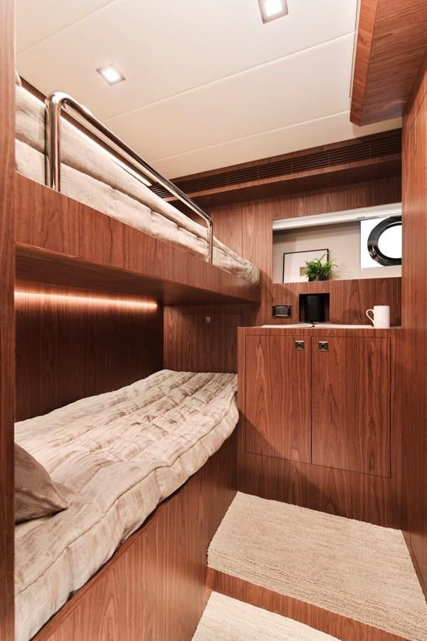 a room with a bed and a mirror aboard HORIZON V77 CMY / AVAILABLE NOW Yacht for Sale