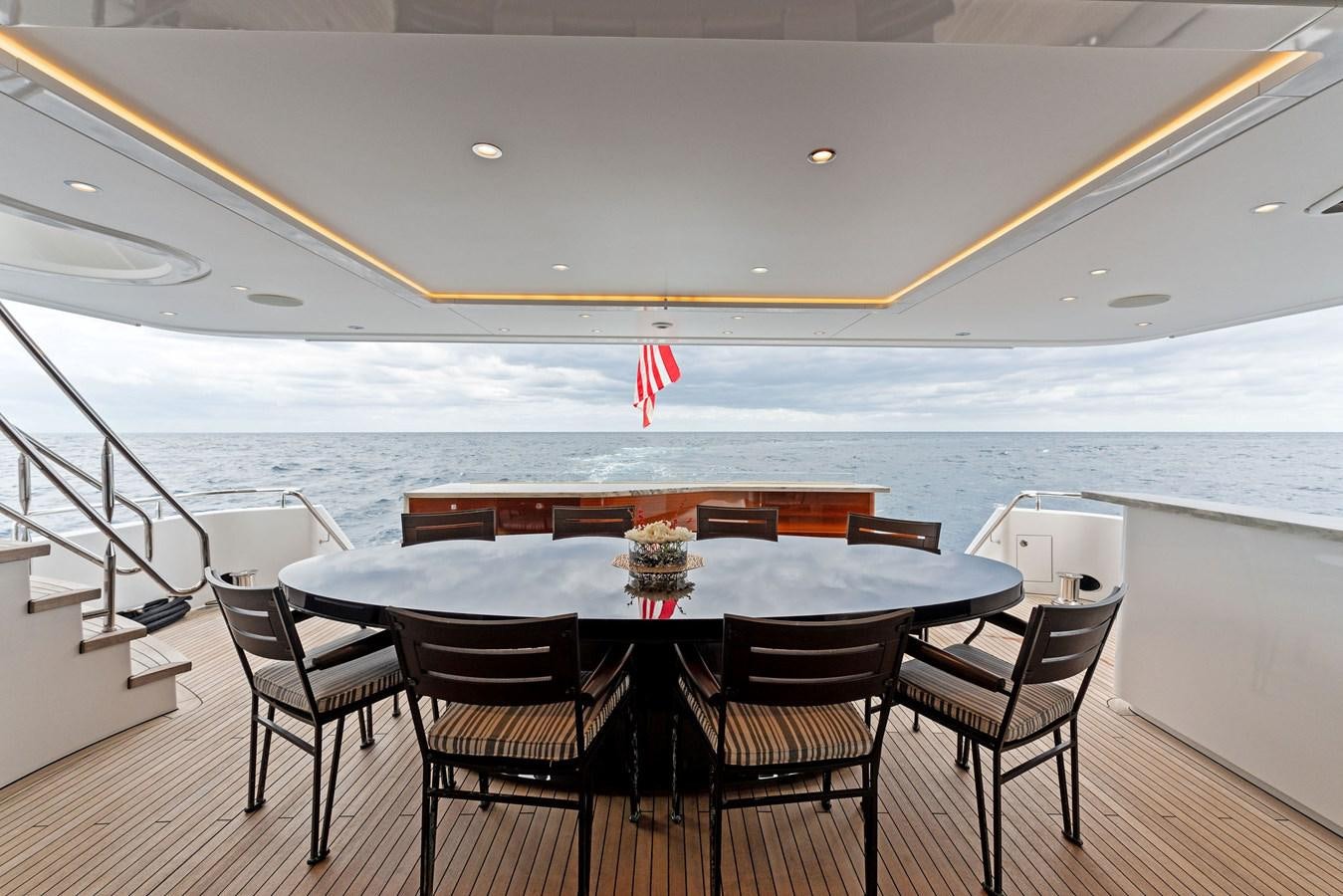 a table with chairs around it aboard SERENITY Yacht for Sale