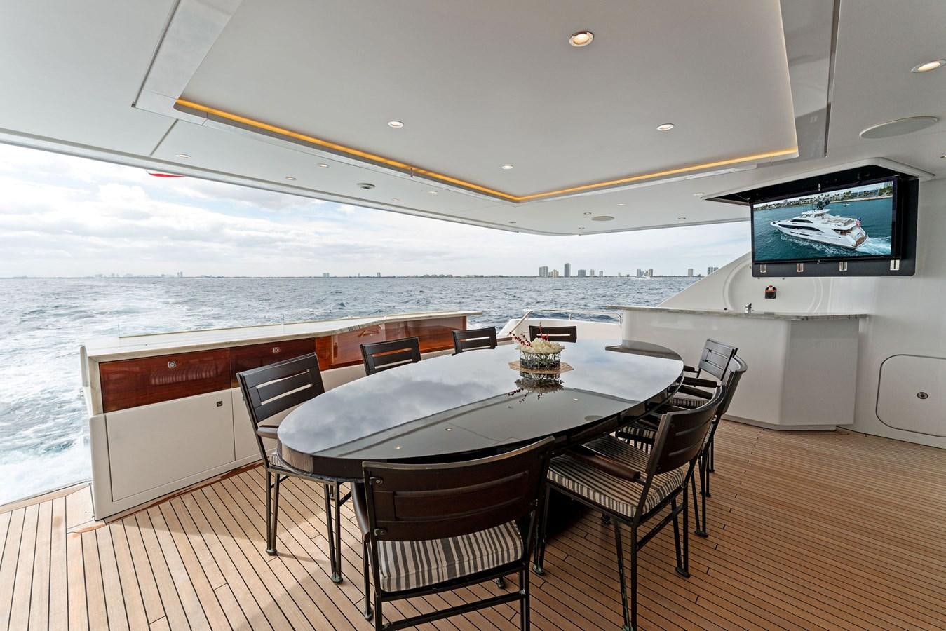 a table and chairs on a deck aboard SERENITY Yacht for Sale