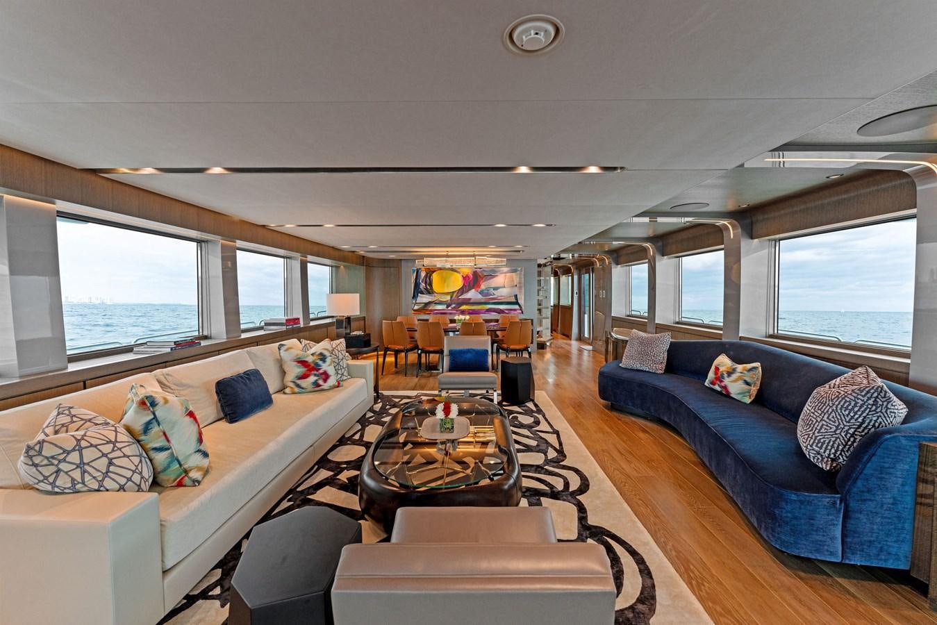 a living room with a couch and a coffee table aboard SERENITY Yacht for Sale