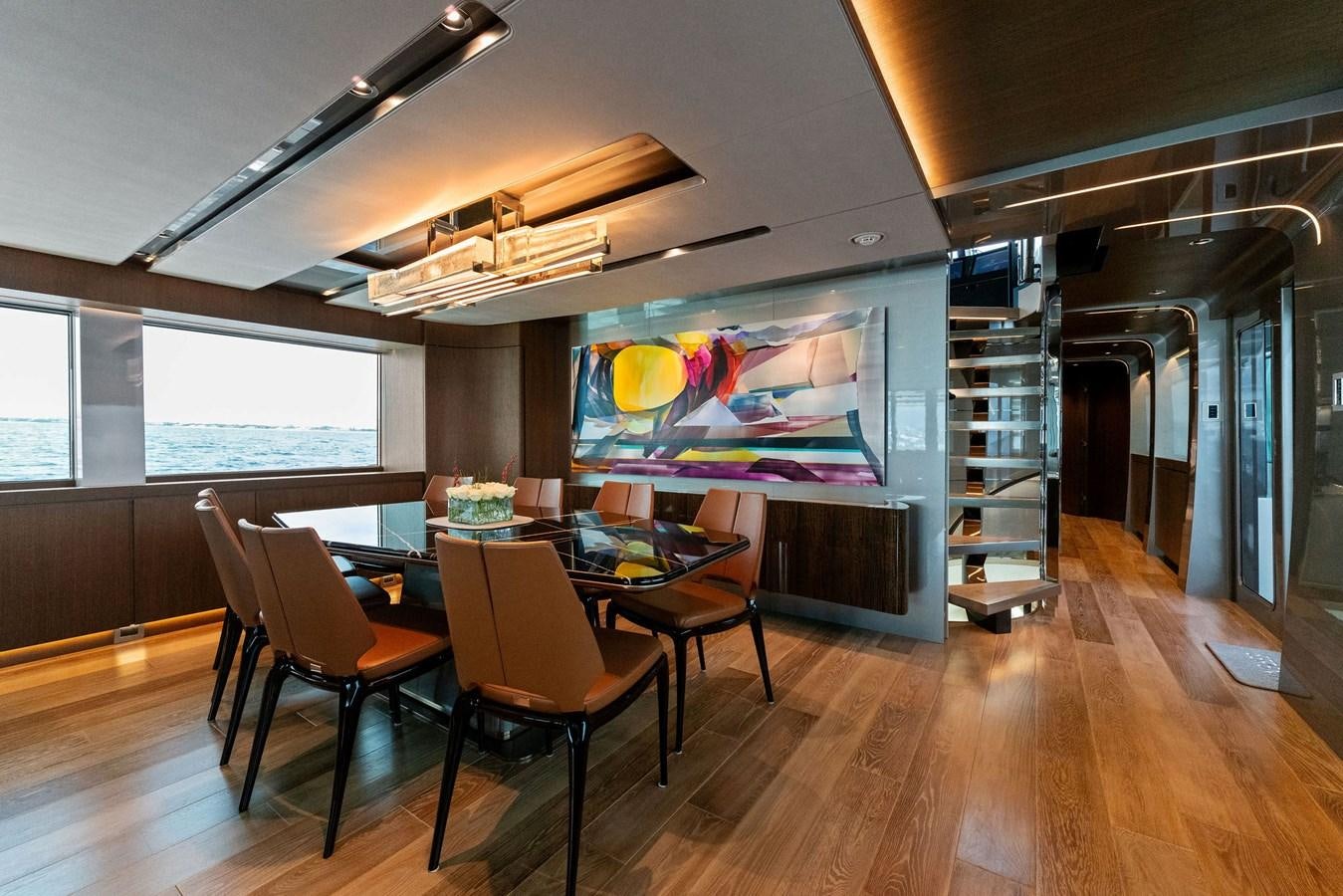 a room with a table and chairs aboard SERENITY Yacht for Sale