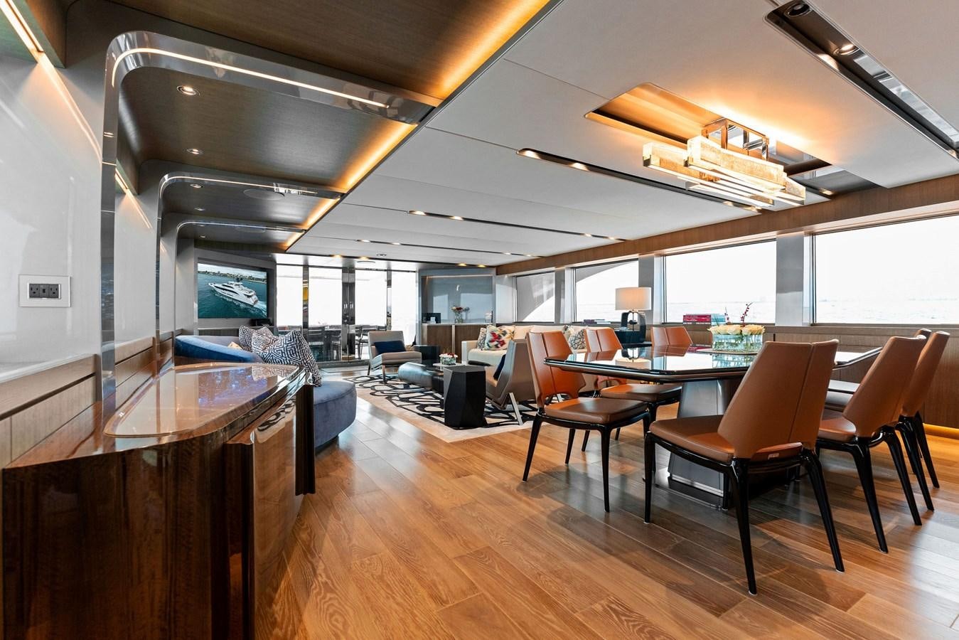 a room with tables and chairs aboard SERENITY Yacht for Sale