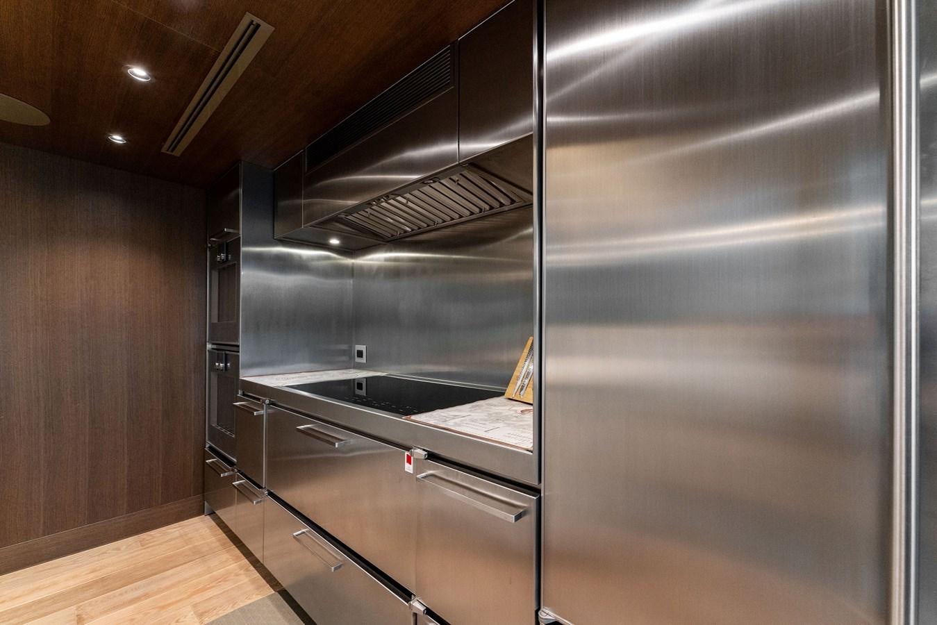 a large kitchen with glass doors aboard SERENITY Yacht for Sale