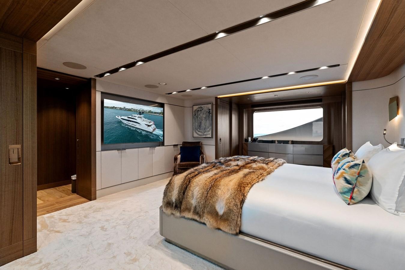 a bedroom with a large screen aboard SERENITY Yacht for Sale