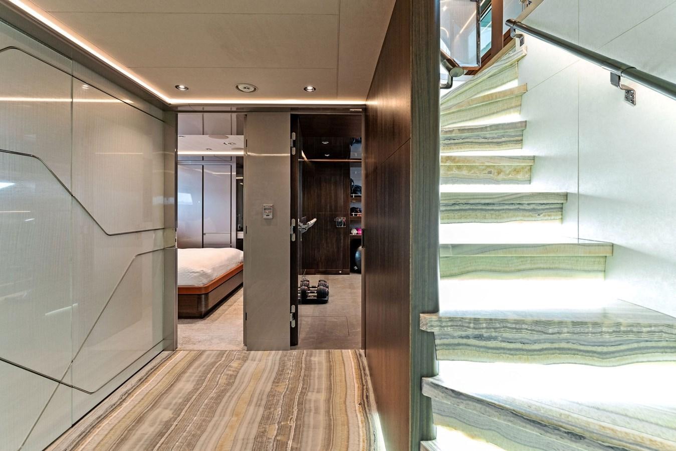 a room with a bed and a door aboard SERENITY Yacht for Sale