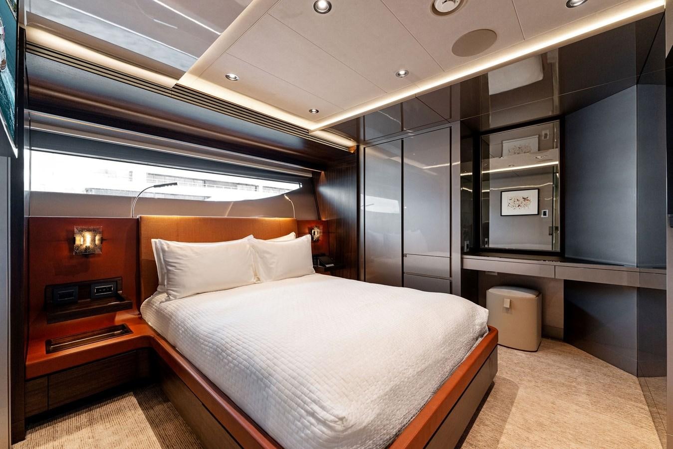 a room with a bed and a desk aboard SERENITY Yacht for Sale