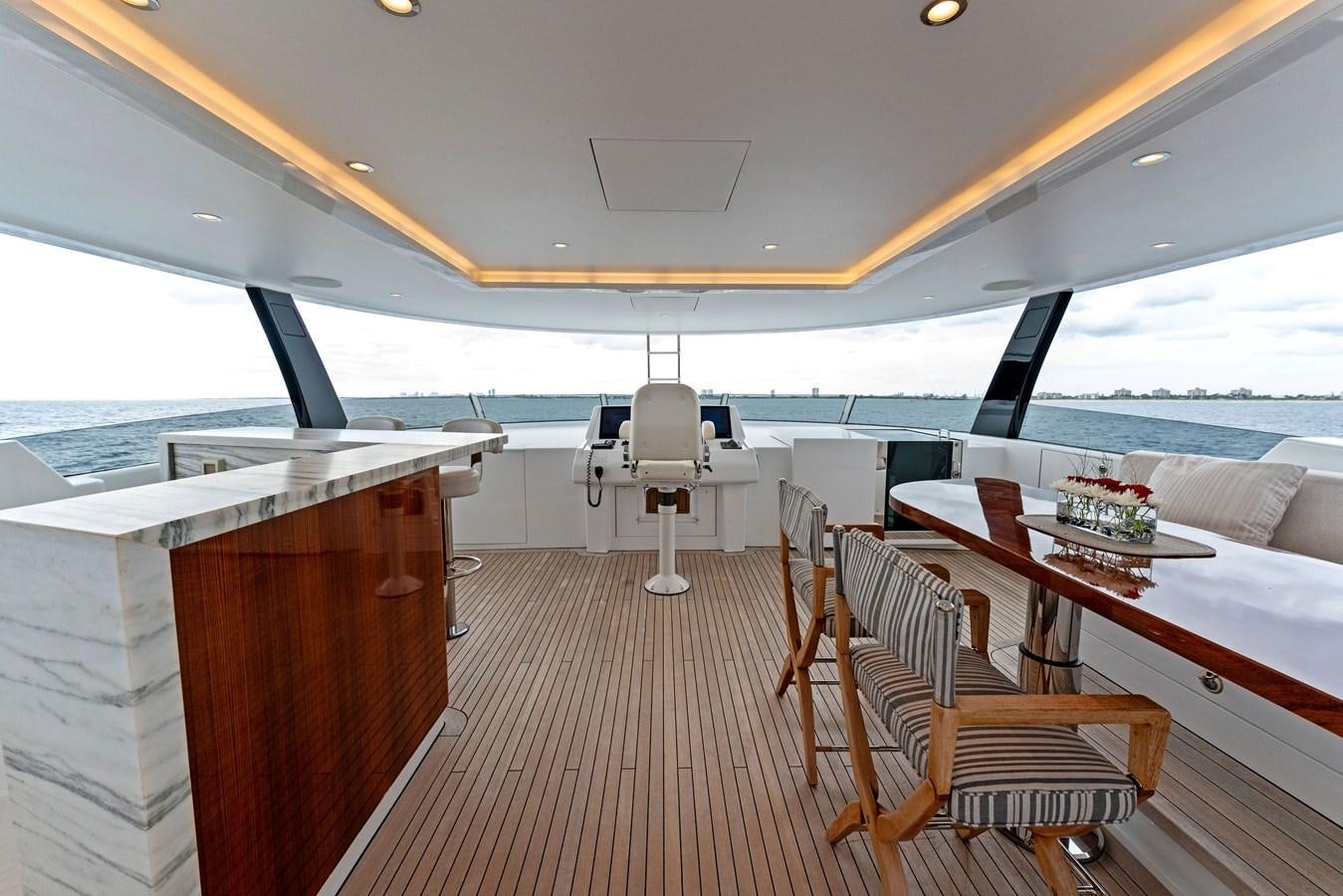 a boat with a table and chairs aboard SERENITY Yacht for Sale