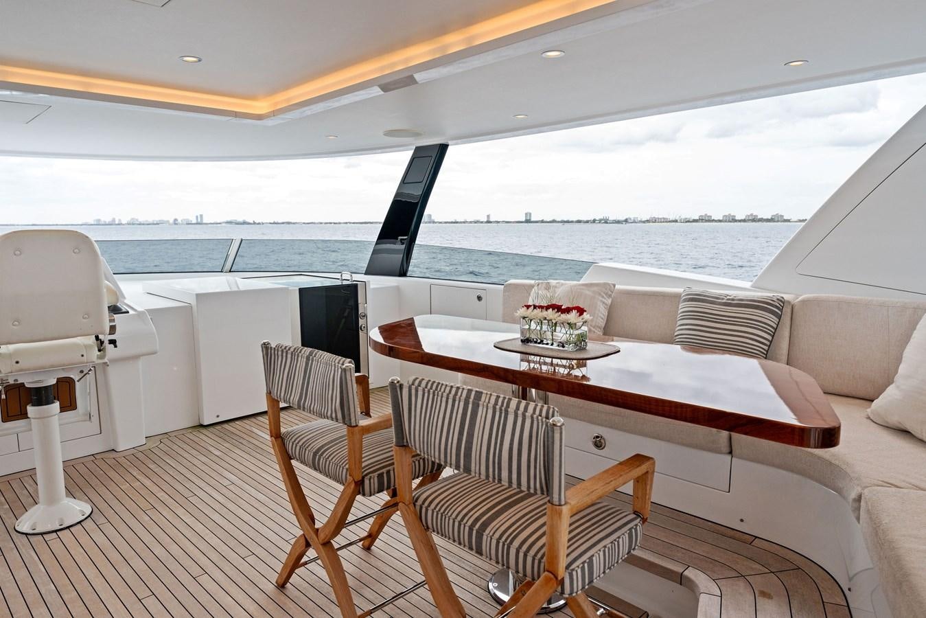 a boat with a table and chairs aboard SERENITY Yacht for Sale