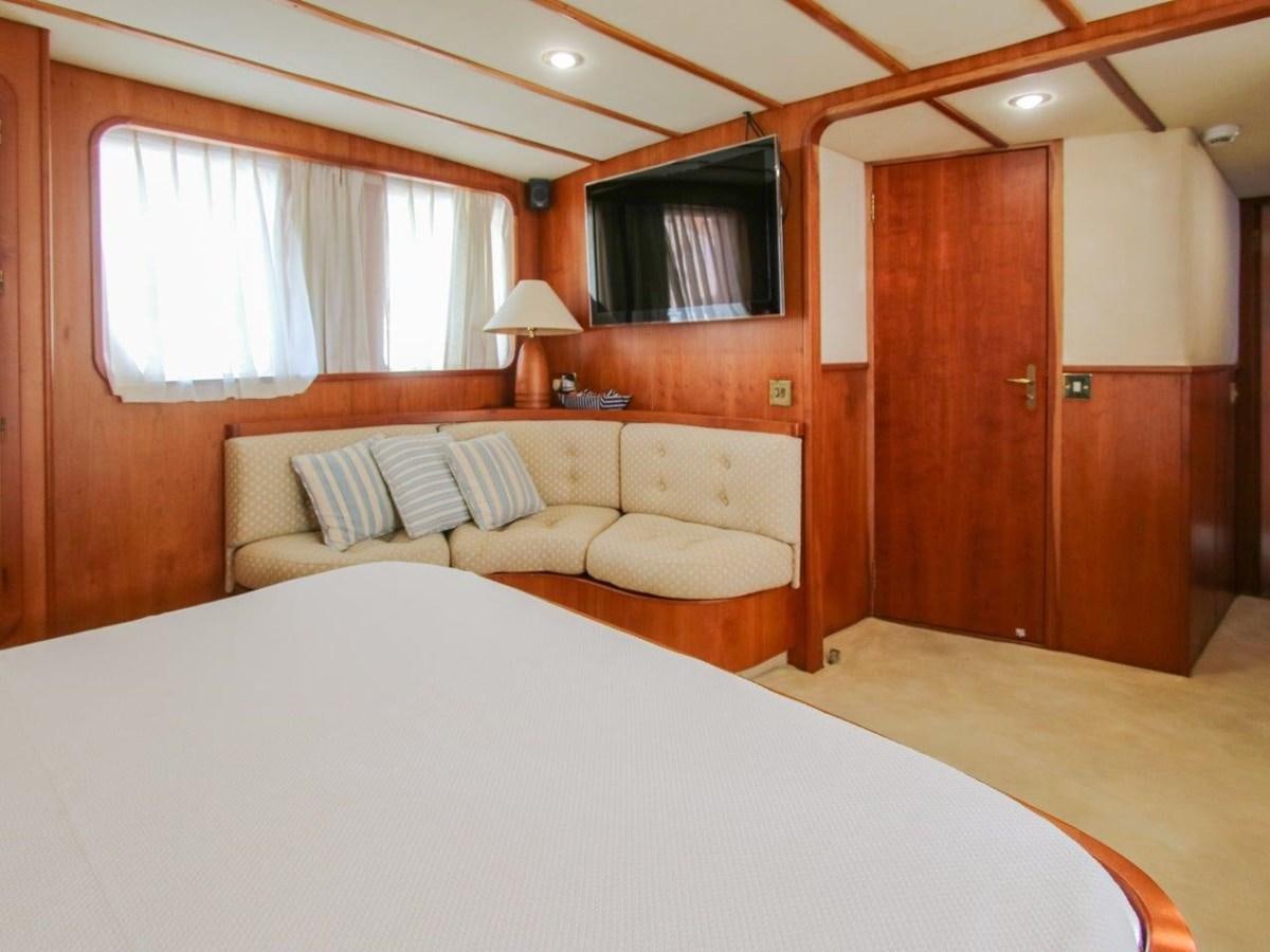 a bedroom with a bed and a window aboard LADY ECOSSE Yacht for Sale