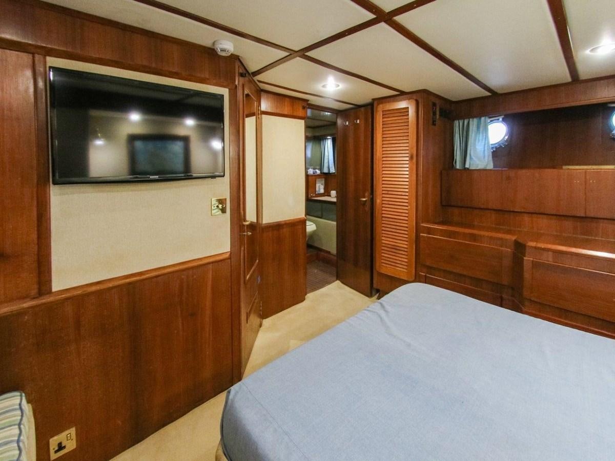 a bedroom with a bed and a television aboard LADY ECOSSE Yacht for Sale