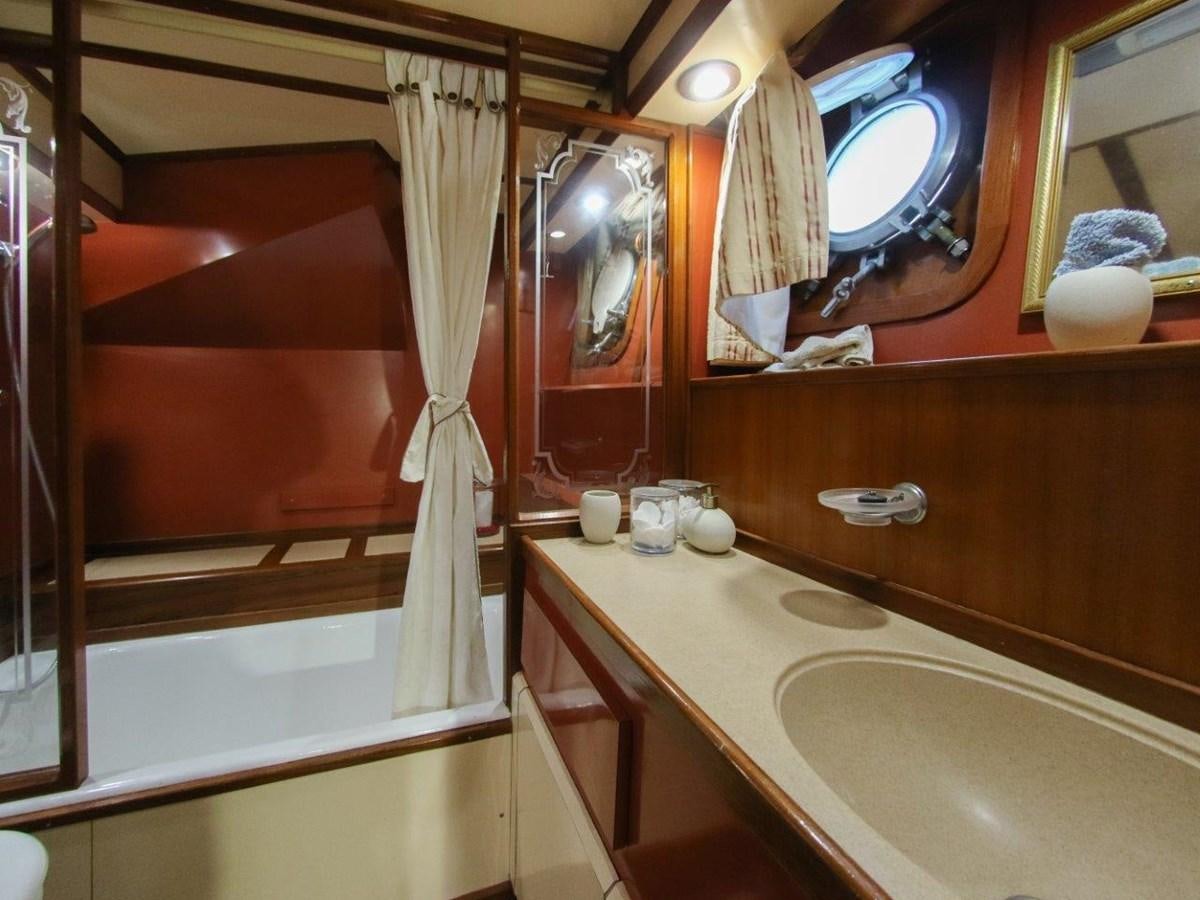 a bathroom with a sink and a mirror aboard LADY ECOSSE Yacht for Sale
