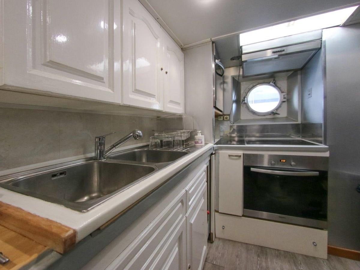 a kitchen with a stove and sink aboard LADY ECOSSE Yacht for Sale
