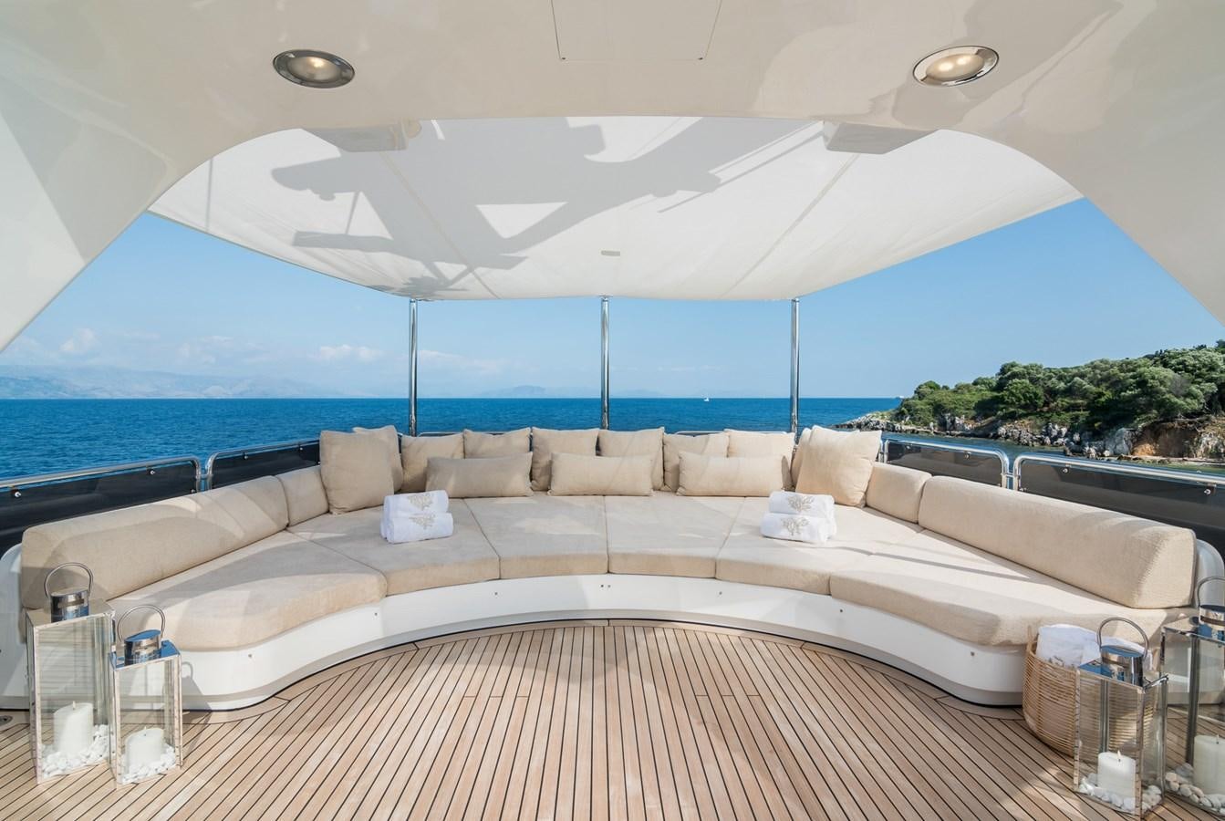 a large white lounge chair next to a large window overlooking the ocean aboard ENDLESS SUMMER Yacht for Sale