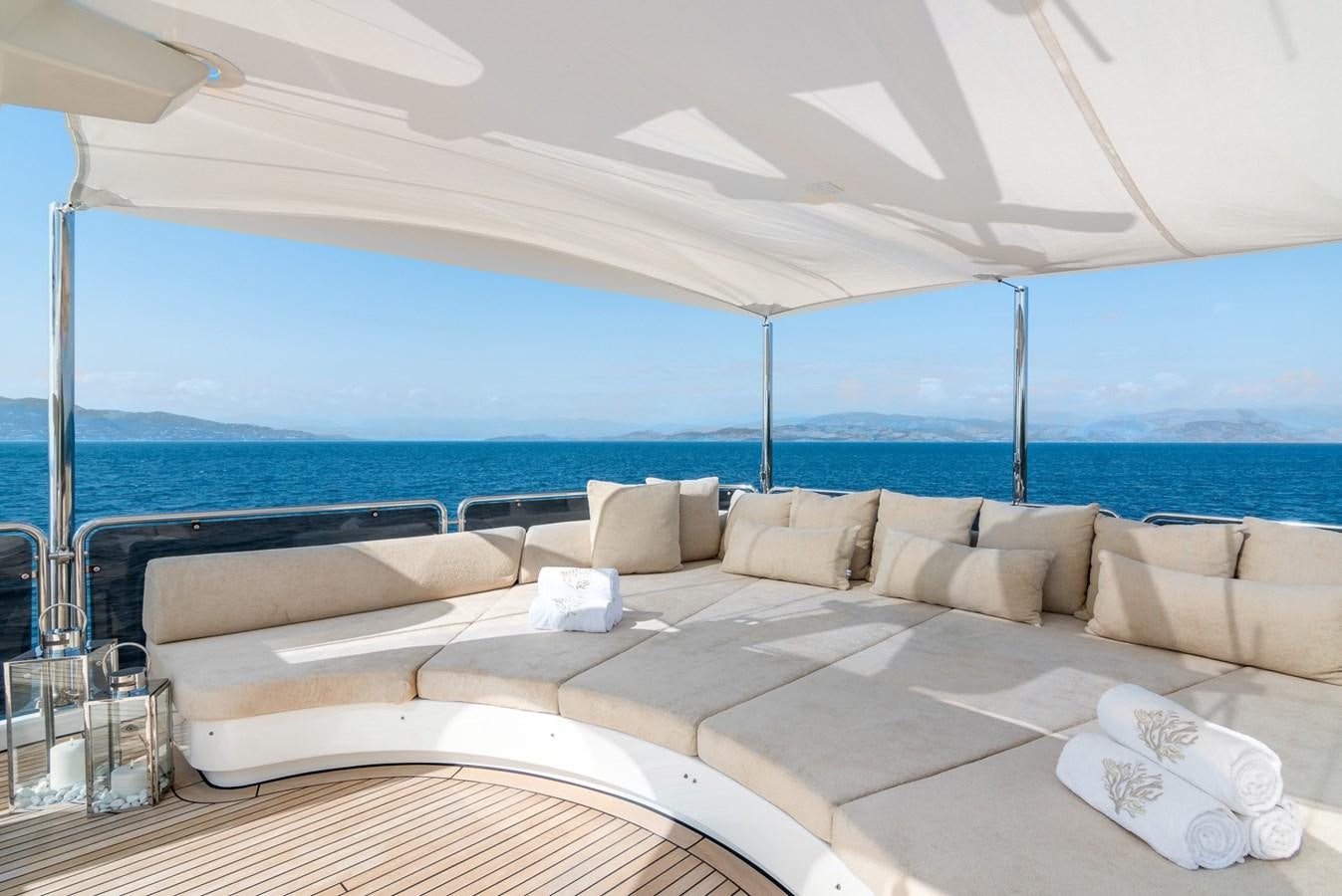 a large lounge area with a large body of water in the background aboard ENDLESS SUMMER Yacht for Sale