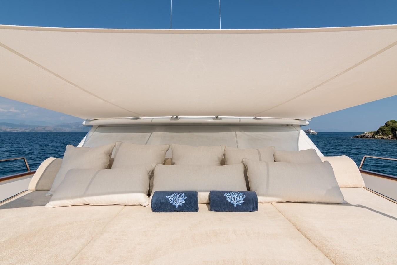 a lounge chair on a beach aboard ENDLESS SUMMER Yacht for Sale