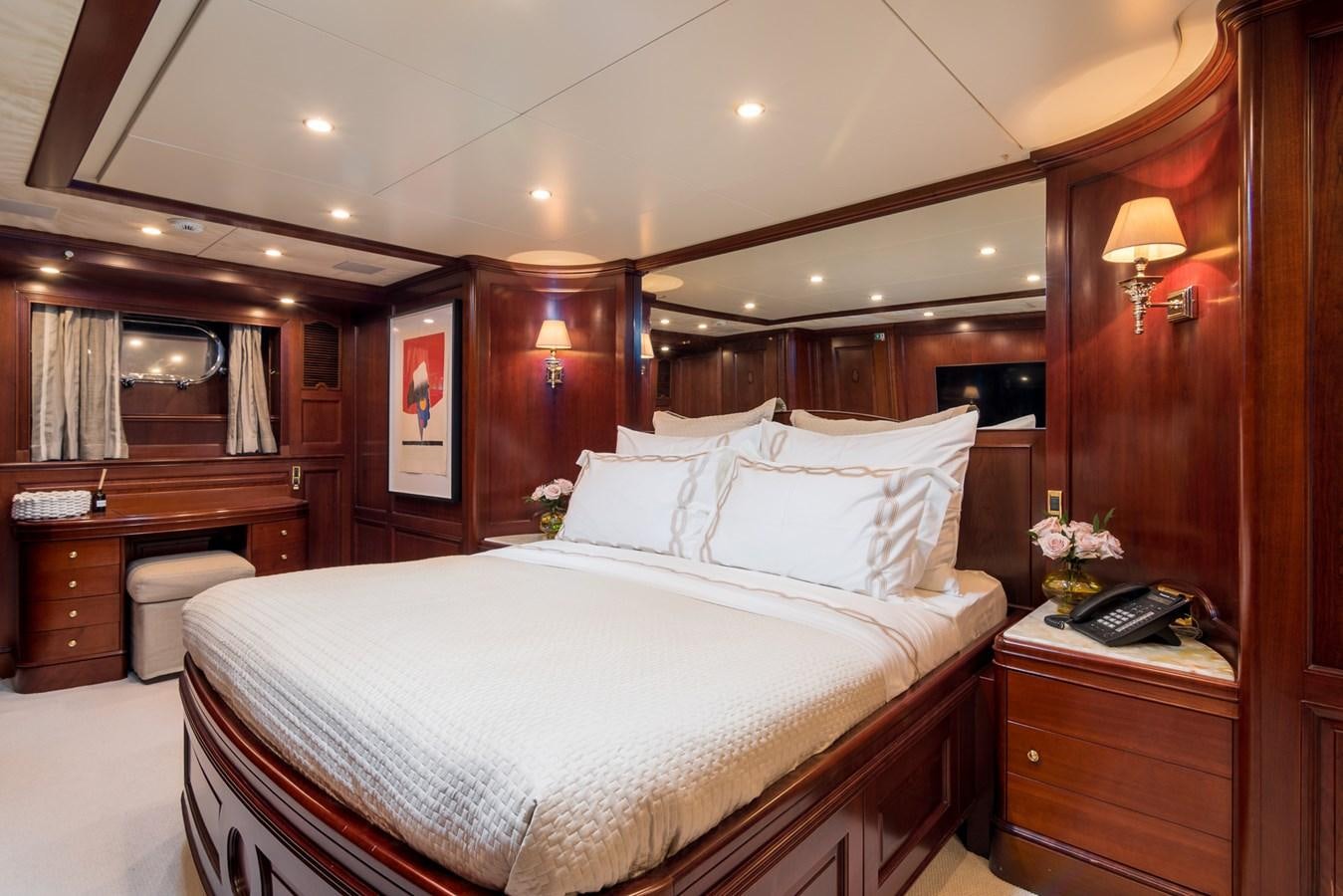 a bed with white sheets and pillows aboard ENDLESS SUMMER Yacht for Sale