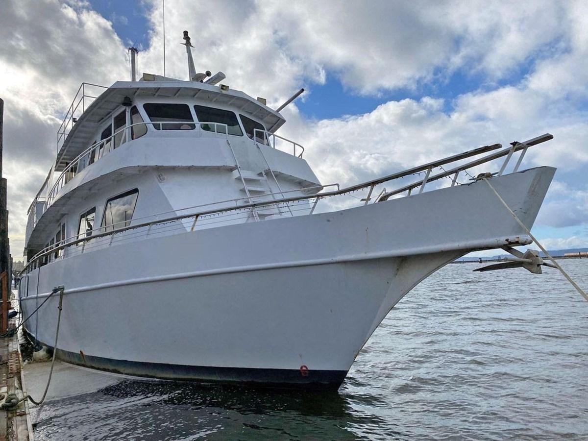a white boat on the water aboard 1986 CUSTOM SEA TREK PASSENGER VESSEL Yacht for Sale