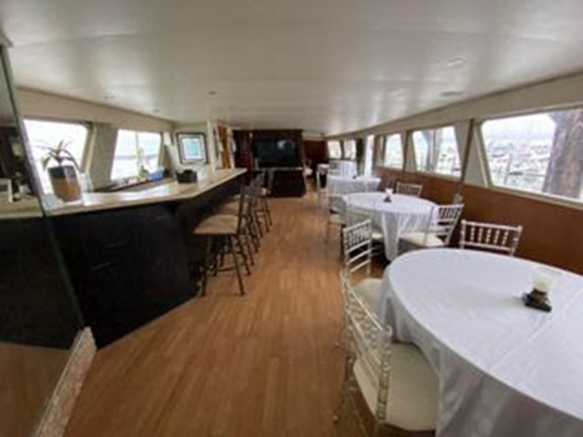 a room with tables and chairs aboard 1986 CUSTOM SEA TREK PASSENGER VESSEL Yacht for Sale
