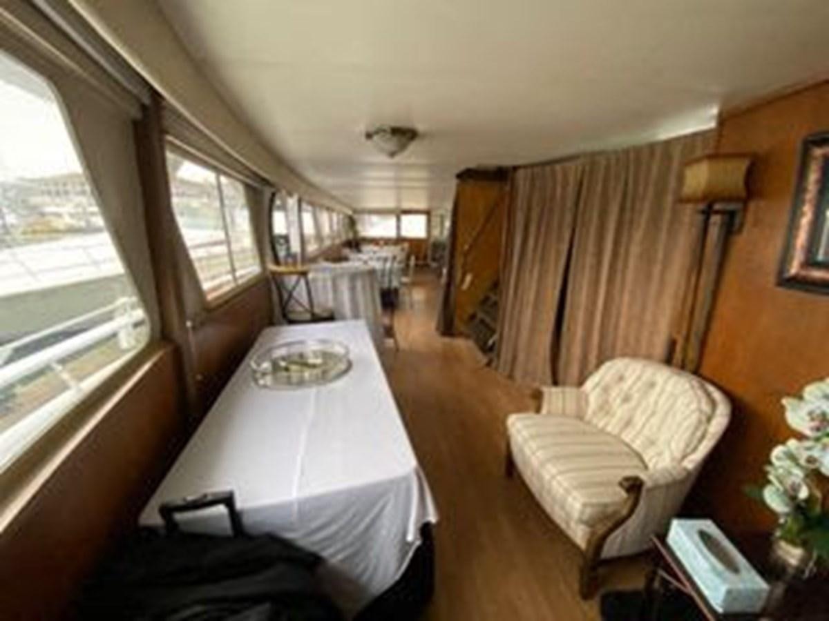 a room with a table and chairs aboard 1986 CUSTOM SEA TREK PASSENGER VESSEL Yacht for Sale