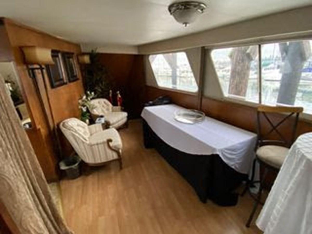 a room with a bed and a table aboard 1986 CUSTOM SEA TREK PASSENGER VESSEL Yacht for Sale