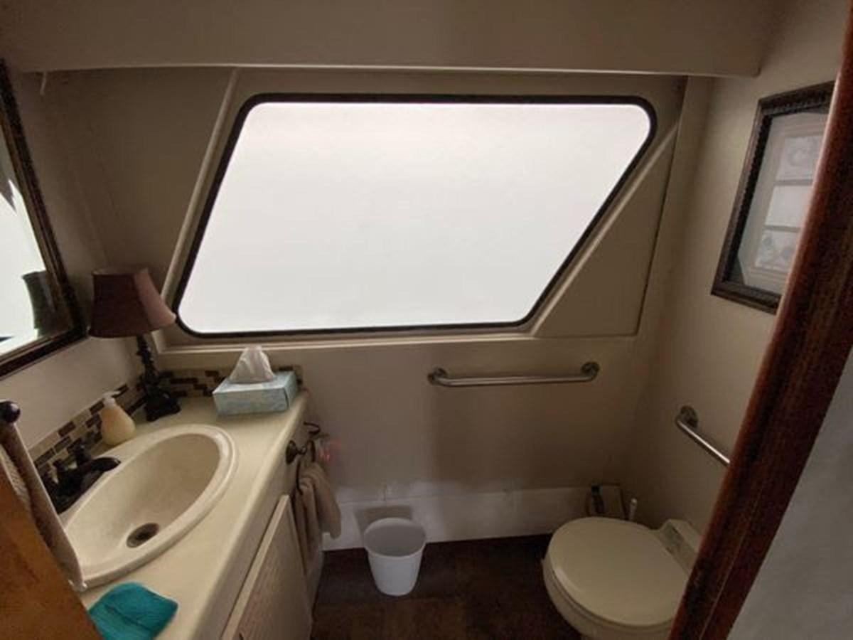 a bathroom with a toilet and a sink aboard 1986 CUSTOM SEA TREK PASSENGER VESSEL Yacht for Sale