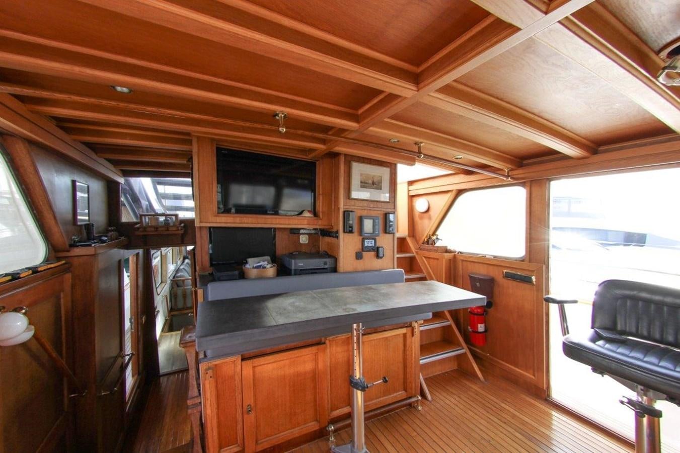 a kitchen with a bar and a table aboard COLUMBUS Yacht for Sale
