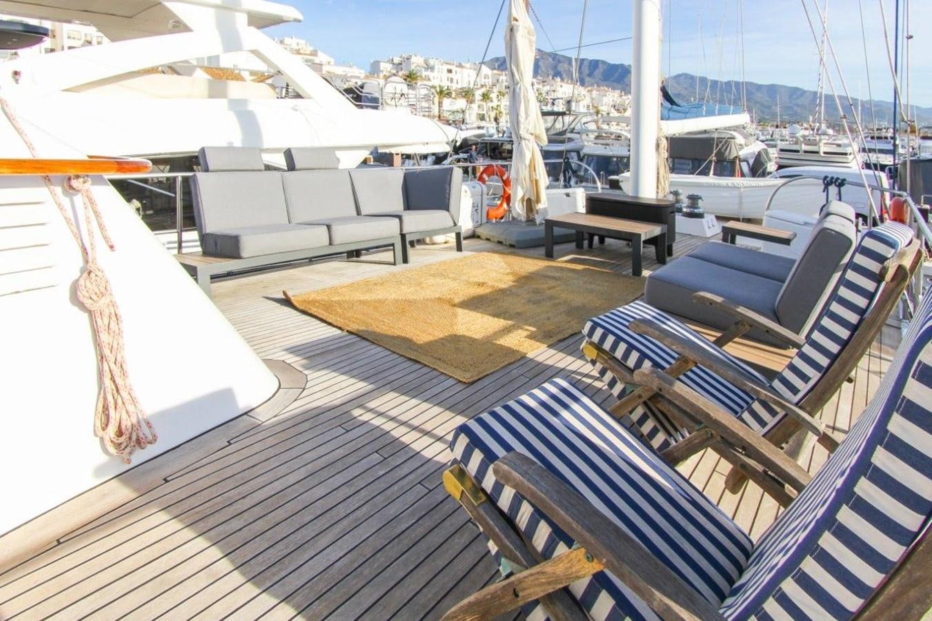 a deck with a deck and chairs aboard COLUMBUS Yacht for Sale
