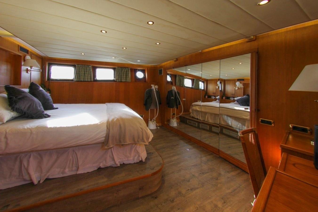 a room with beds and a mirror aboard COLUMBUS Yacht for Sale
