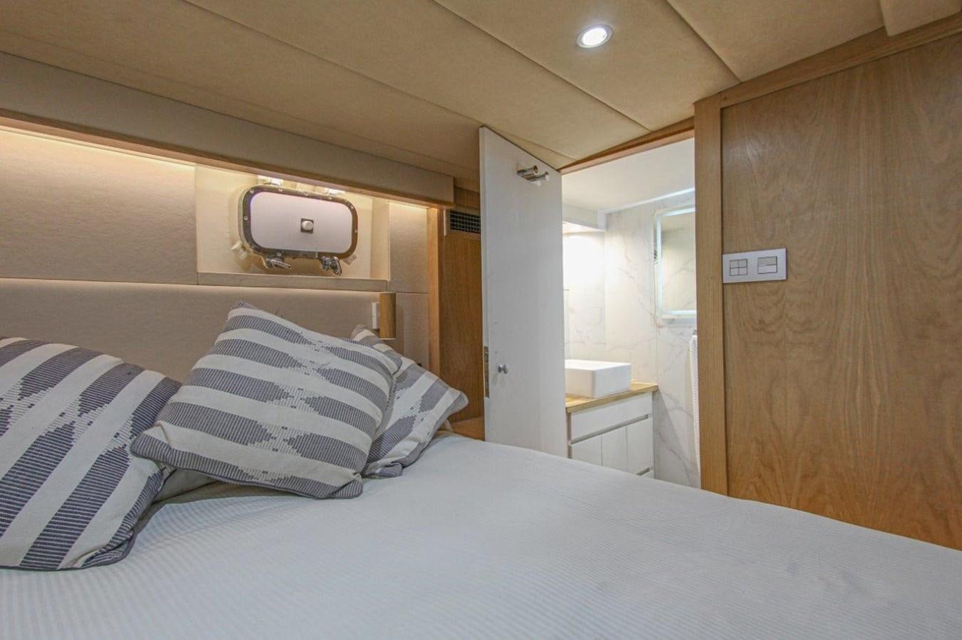 a bed with white sheets aboard COLUMBUS Yacht for Sale