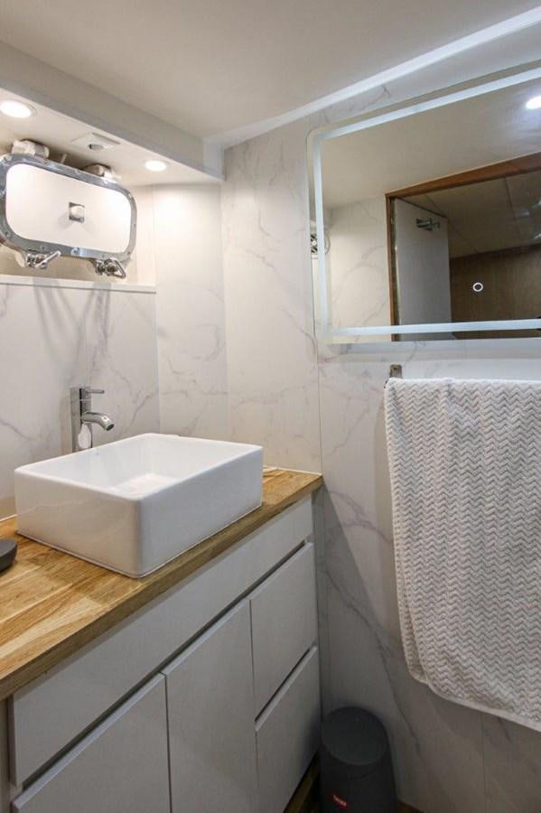 a bathroom with a sink and mirror aboard COLUMBUS Yacht for Sale