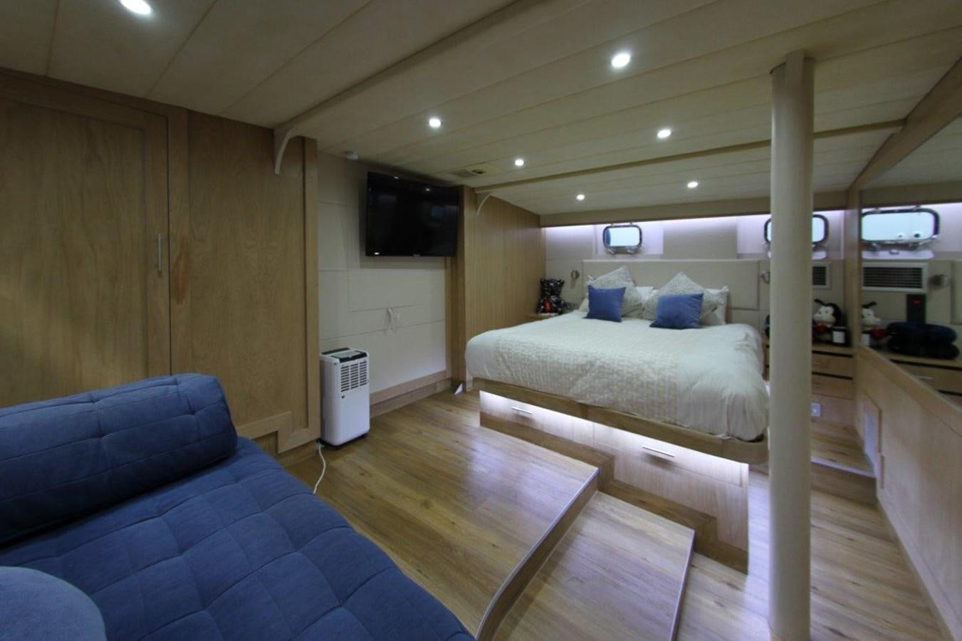 a room with a bed and a couch aboard COLUMBUS Yacht for Sale