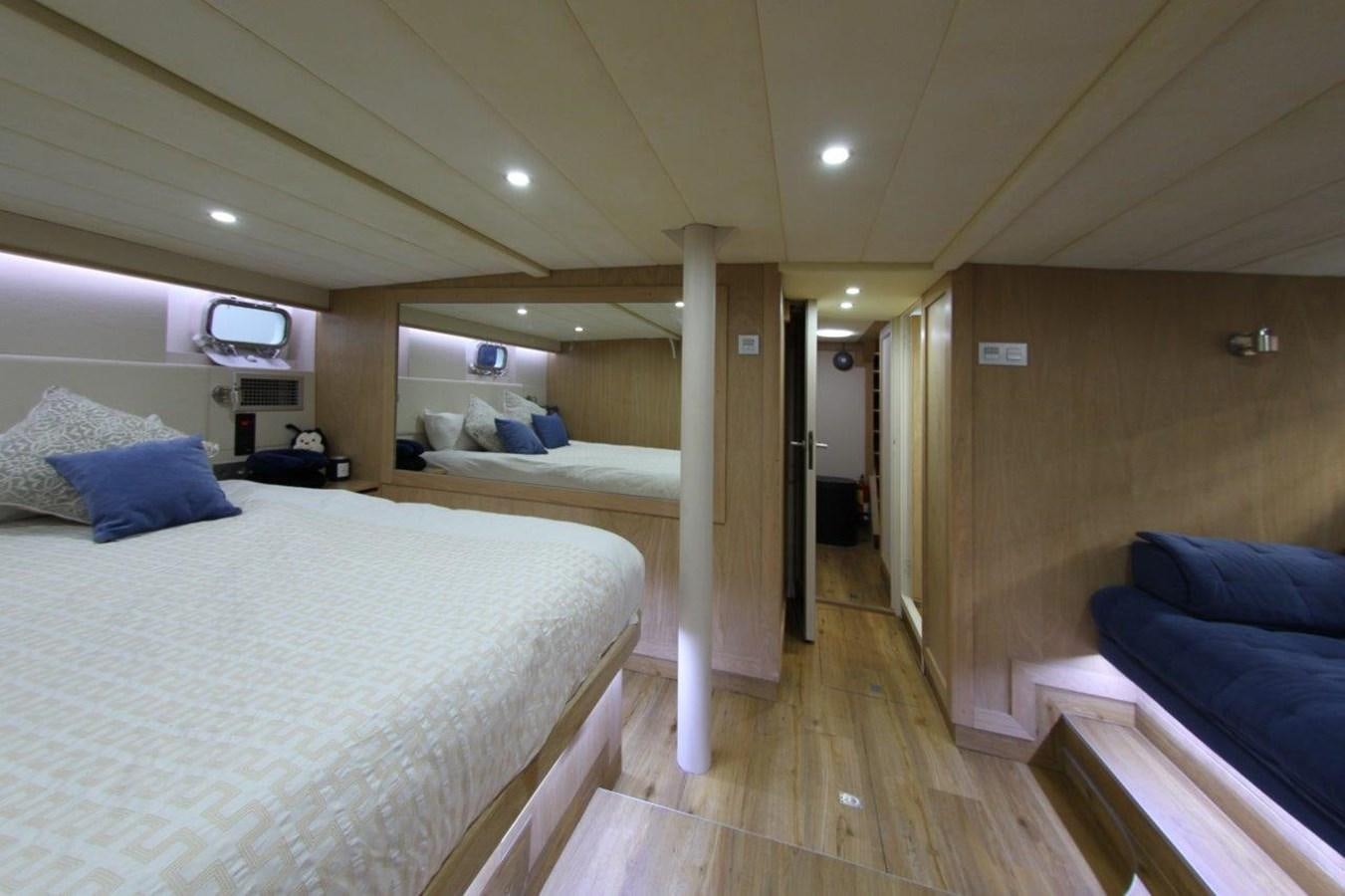 a room with a bed and a couch aboard COLUMBUS Yacht for Sale