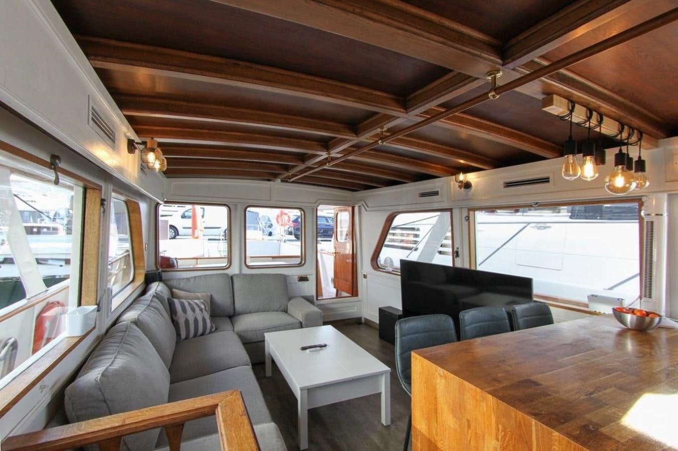 a room with a couch and a table aboard COLUMBUS Yacht for Sale