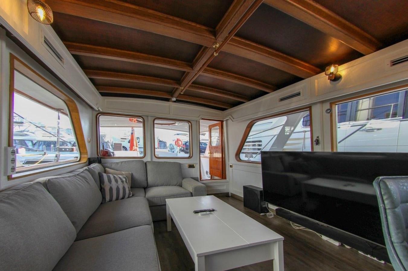 inside of a vehicle with a table and chairs and a window aboard COLUMBUS Yacht for Sale