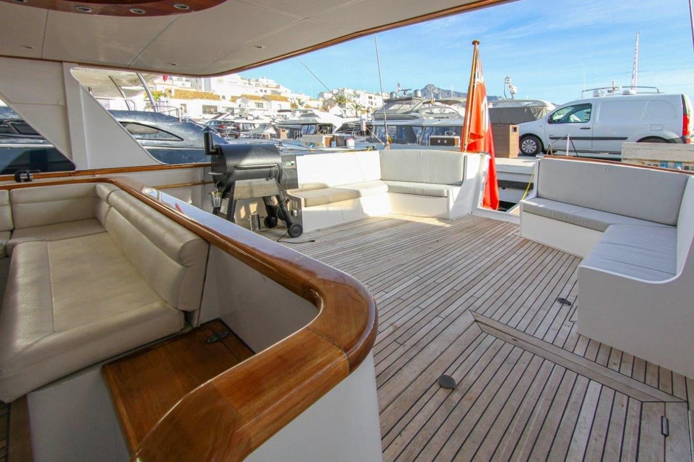 a deck with a view of the water and boats aboard COLUMBUS Yacht for Sale