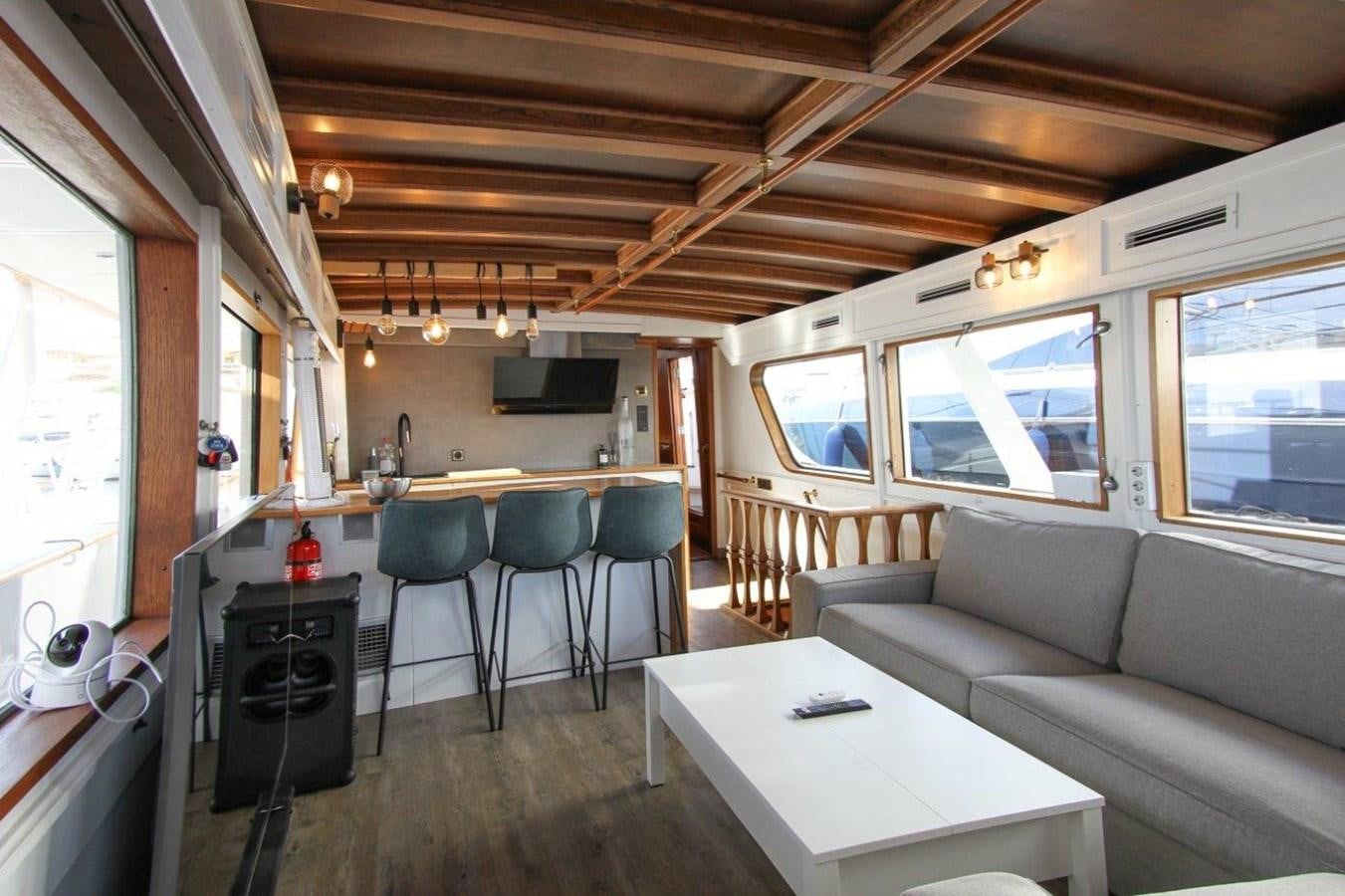 a living room with a couch and a table aboard COLUMBUS Yacht for Sale