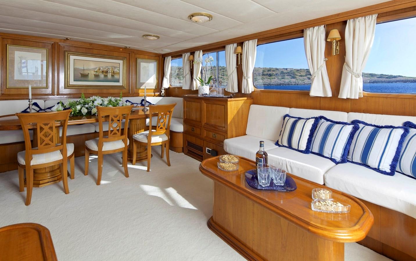 a living room with a couch and a table aboard HERMINA Yacht for Sale