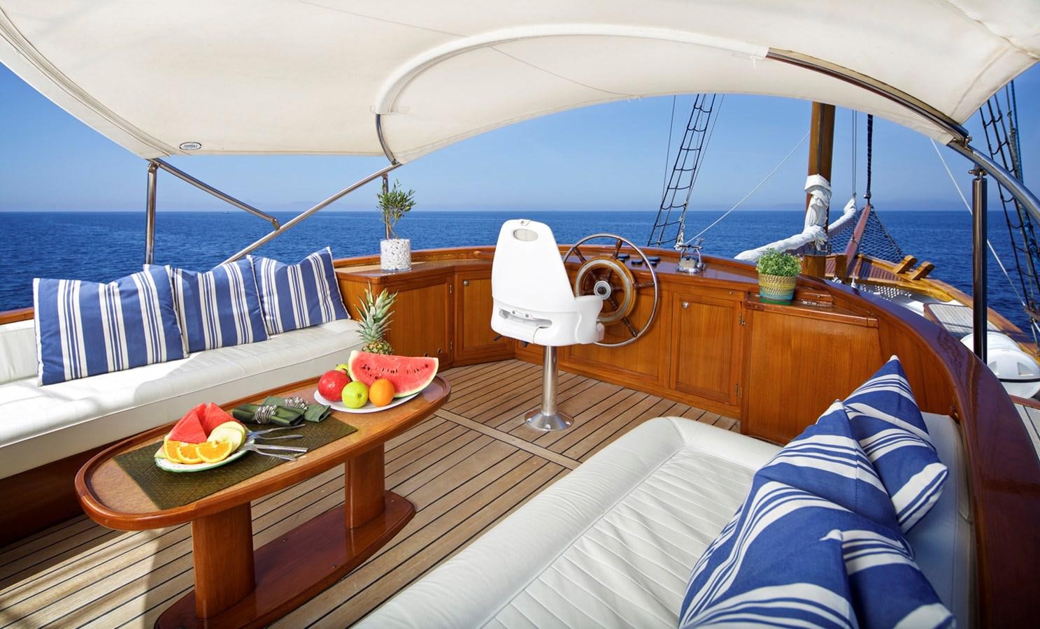a boat with a table and a bed with fruit on it aboard HERMINA Yacht for Sale