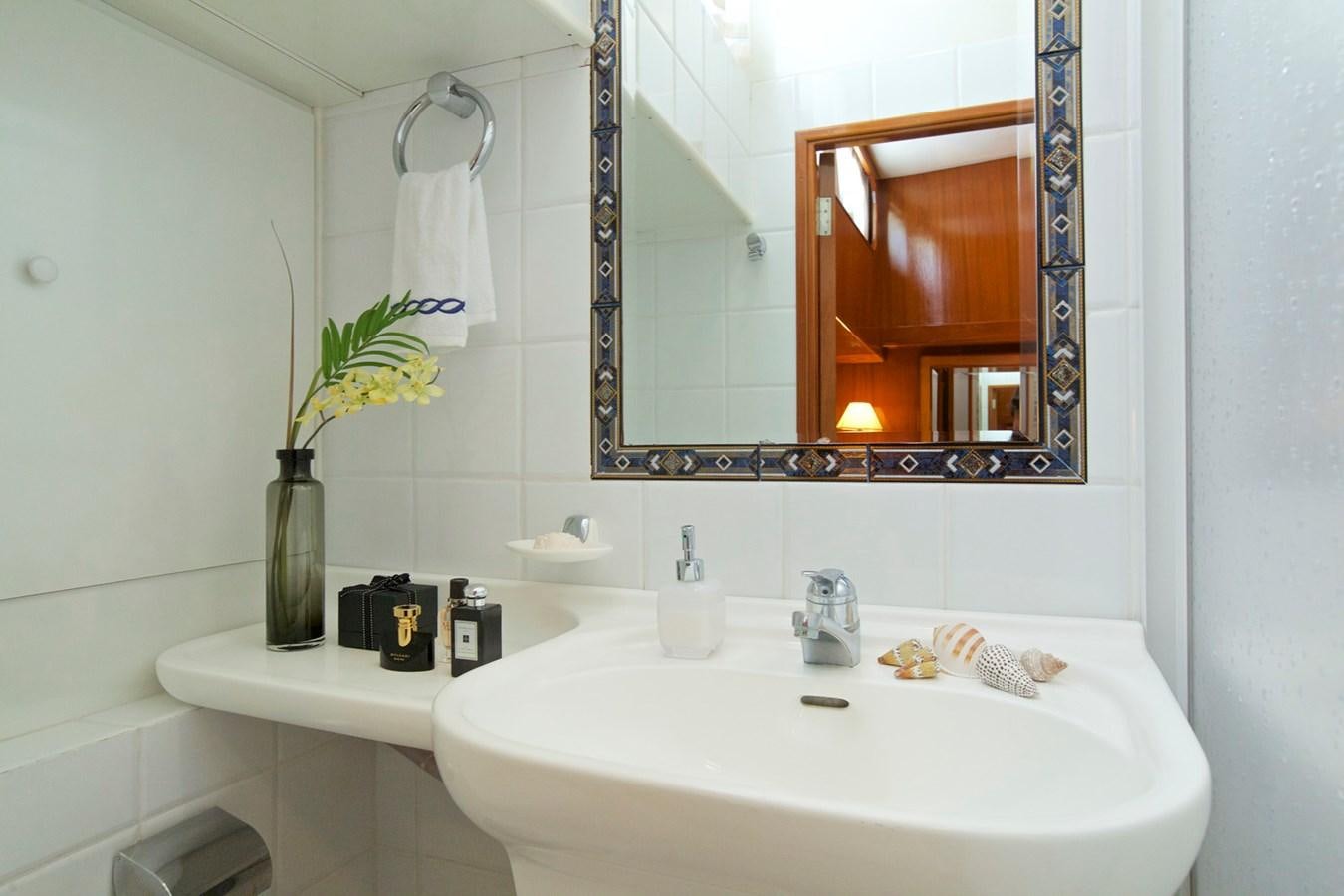 a bathroom with a sink and mirror aboard HERMINA Yacht for Sale