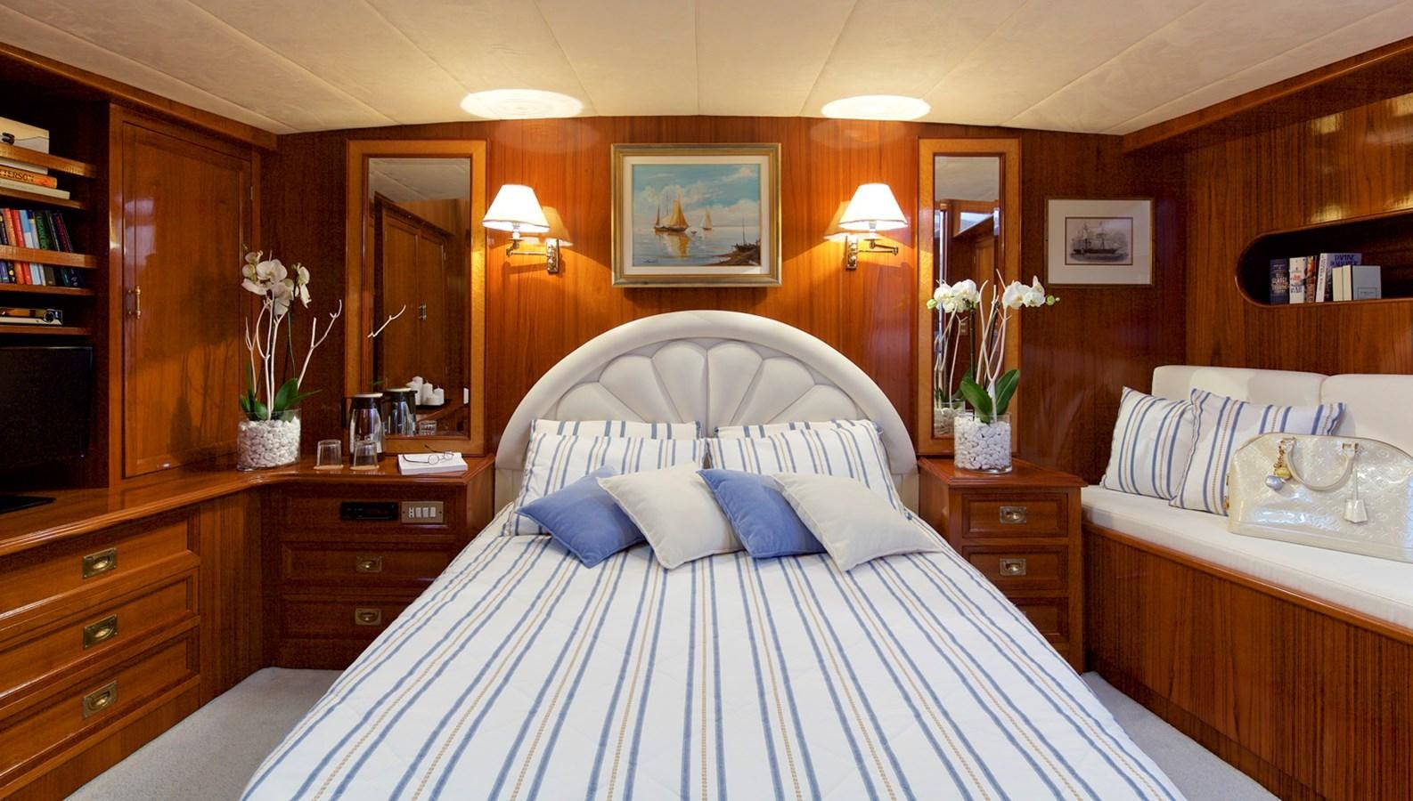 a room with a bed and a mirror aboard HERMINA Yacht for Sale