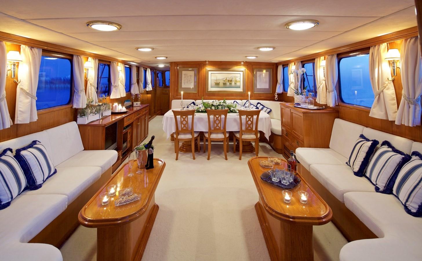 a living room with a table and chairs aboard HERMINA Yacht for Sale