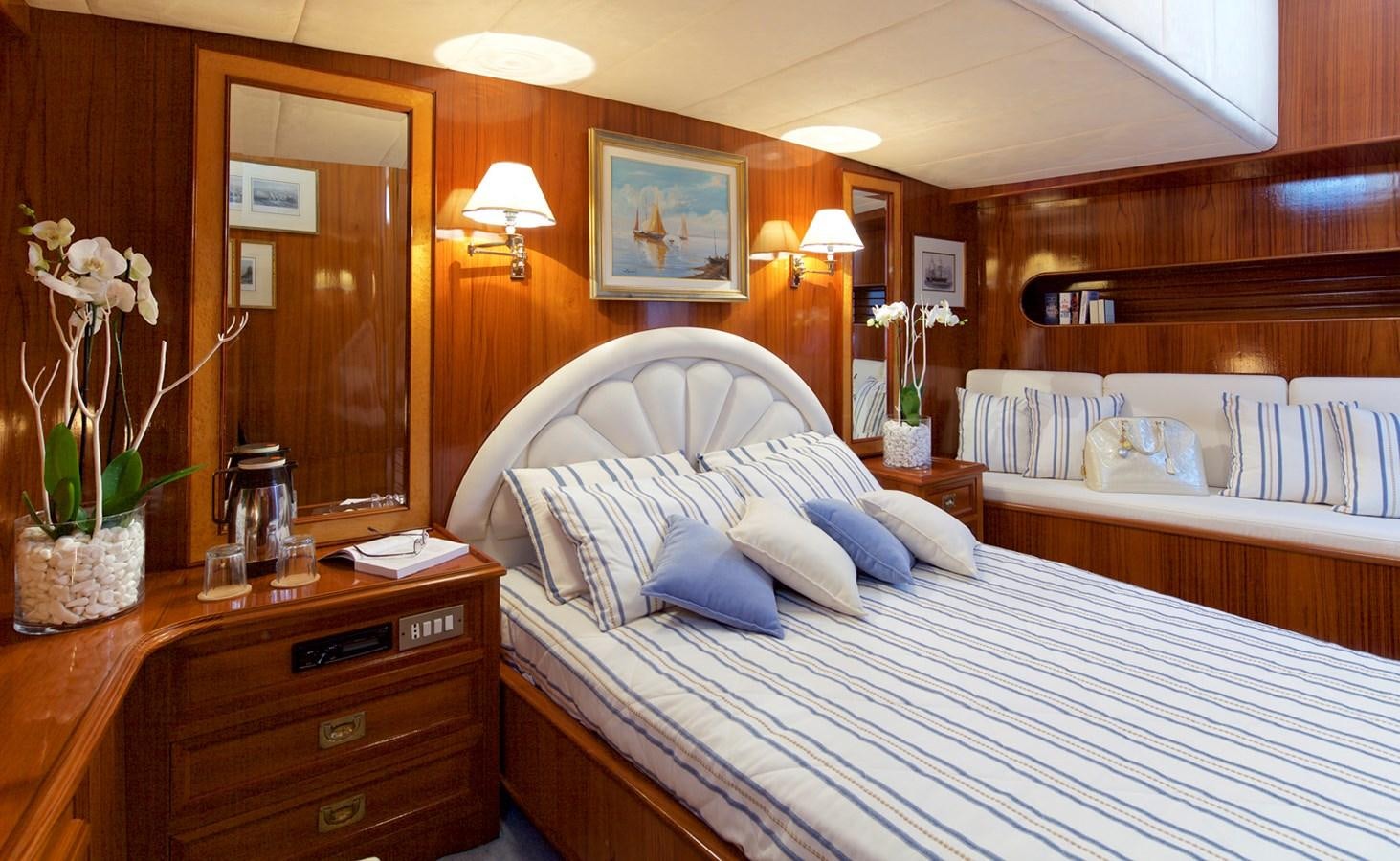 a hotel room with a bed and a dresser aboard HERMINA Yacht for Sale