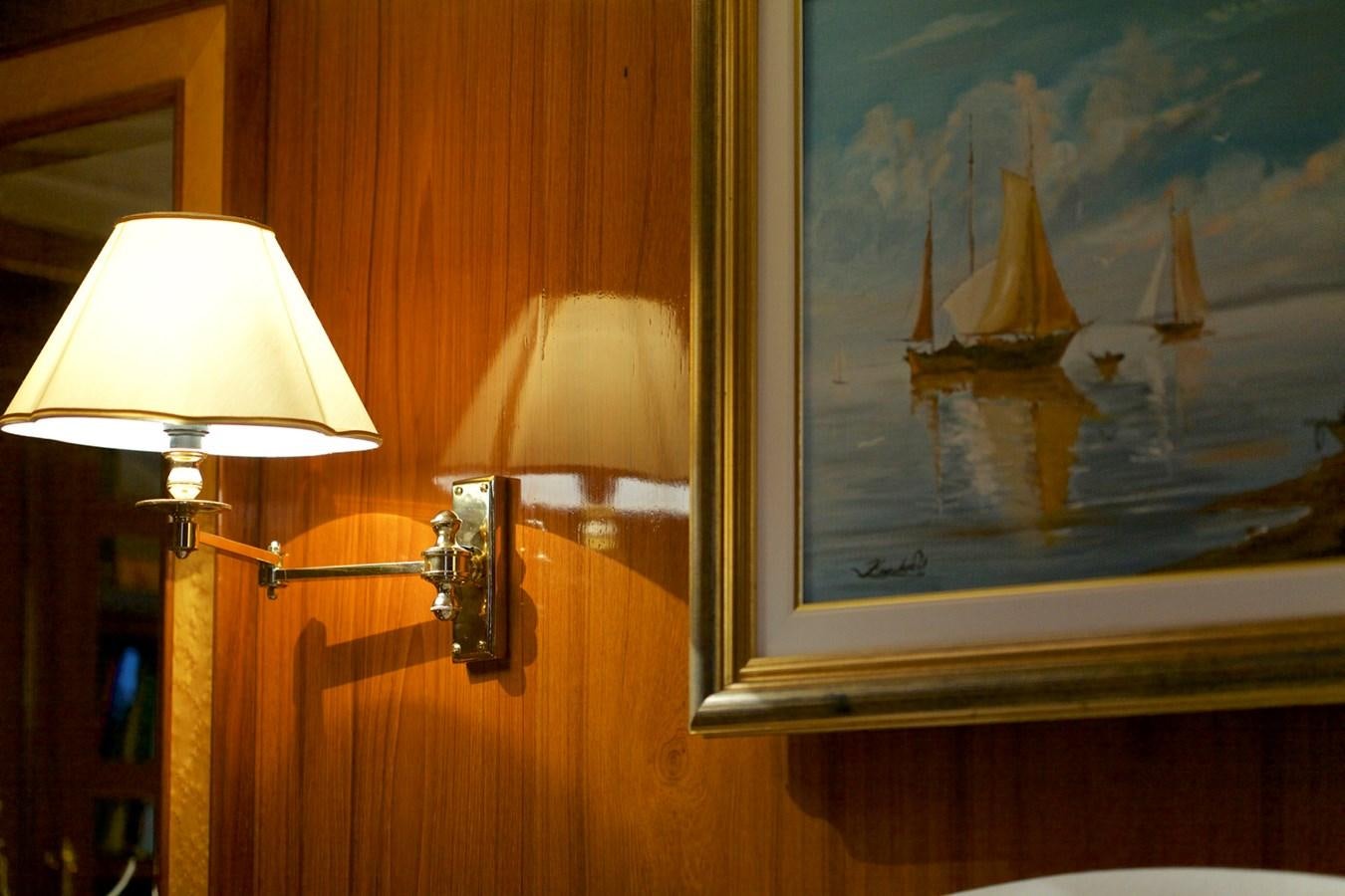 a lamp next to a painting aboard HERMINA Yacht for Sale