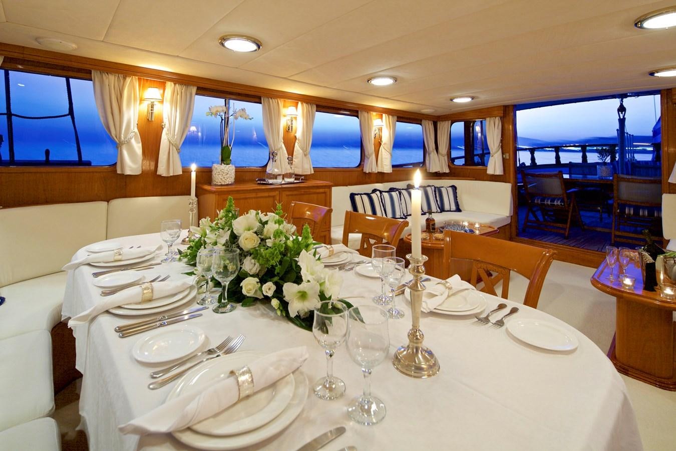 a table set for a formal dinner aboard HERMINA Yacht for Sale